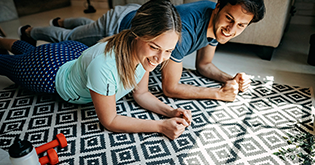 Young couple, planking on a rug