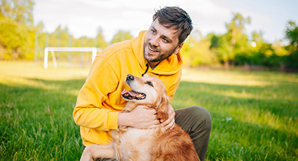 Man with a dog in the garden